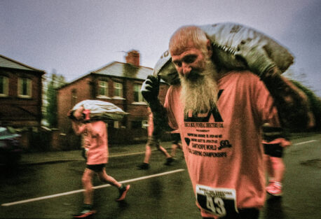 A man carrying a sack of coal in a race by Simon Hill, part of The North Revisited exhibition at Jodrell Bank.